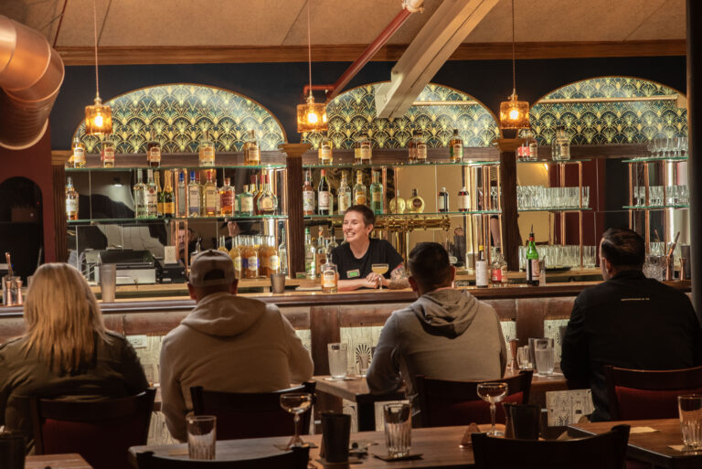 Guests seated at a bar during a whiskey tasting at Old Savannah Distillery